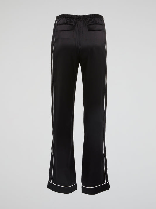 Feel bold and sophisticated in these Black Contrast Lining Flared Pants by Roberto Cavalli. The sleek silhouette and dramatic flared legs effortlessly elevate any outfit, making you stand out in a crowd. Embrace your fashion-forward style and turn heads wherever you go with these statement-making pants.