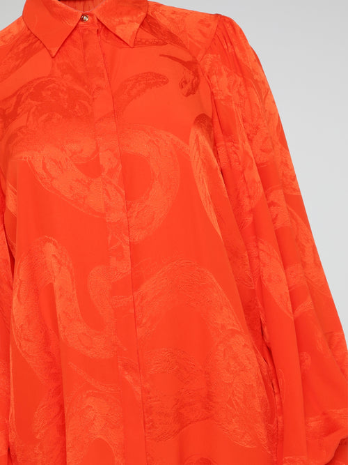 Unleash your wild side with this striking Orange Snake Print Blouse from the iconic Roberto Cavalli. Crafted with luxurious silk fabric, this statement piece features a bold snake print pattern that is sure to turn heads wherever you go. Embrace your inner fashionista and make a fierce style statement with this must-have addition to your wardrobe.