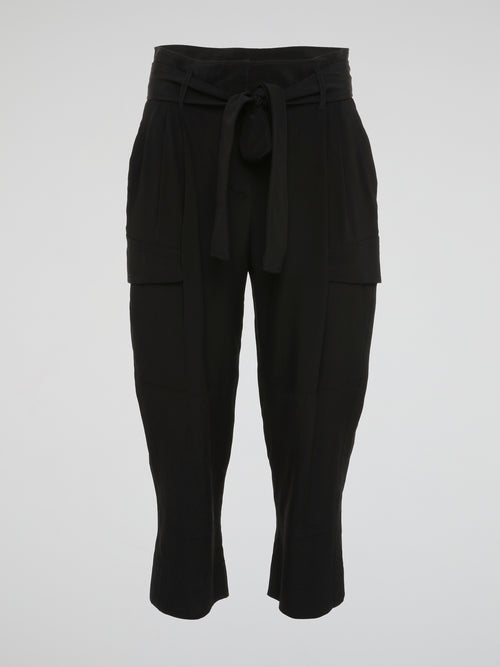 Feel fierce and fabulous in these Black Cargo Capris by Roberto Cavalli - a must-have staple for your wardrobe. The edgy cargo pockets add a unique touch to these versatile capris, perfect for any occasion. Make a statement and turn heads wherever you go with these chic and stylish capris.