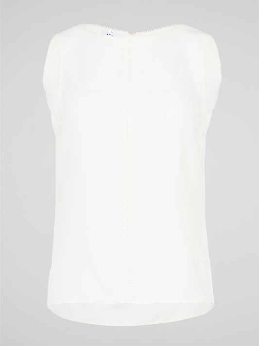 Introducing a timeless masterpiece for fashion-forward mavens - the White Sleeveless Top by Akris Punto. This ethereal beauty effortlessly combines sophistication and elegance with its minimalist design and impeccable tailoring. Crafted from luxurious fabrics, it's the perfect versatile piece to elevate your style, ensuring you're the epitome of chic from desk to dinner.