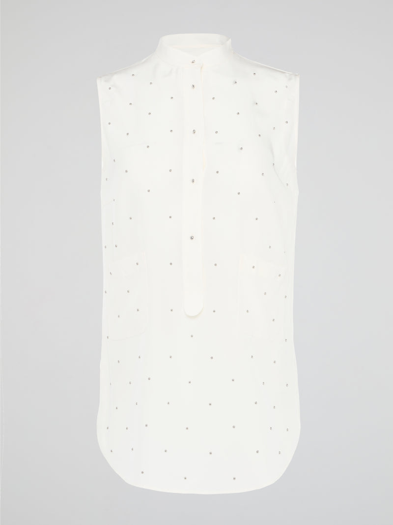 Unleash your fierce, fashion-forward side with the White Studded Sleeveless Shirt by Akris Punto. Crafted with meticulous attention to detail, this statement piece is adorned with intricately placed studs that exude edgy sophistication. Perfectly blending poise and rebellious spirit, this sleeveless shirt is a captivating must-have for those seeking to redefine their style game.