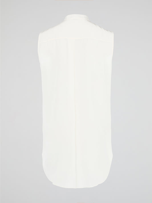 Unleash your fierce, fashion-forward side with the White Studded Sleeveless Shirt by Akris Punto. Crafted with meticulous attention to detail, this statement piece is adorned with intricately placed studs that exude edgy sophistication. Perfectly blending poise and rebellious spirit, this sleeveless shirt is a captivating must-have for those seeking to redefine their style game.