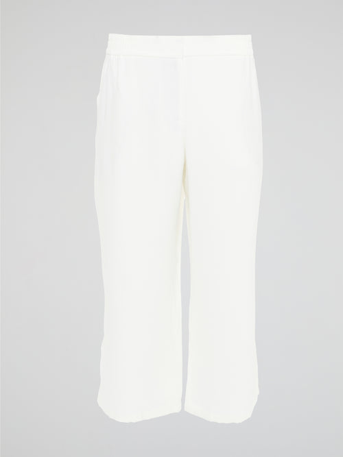 Introducing the ultimate embodiment of chic and comfort - the White Wide Leg Cropped Pants by Akris Punto. Crafted with meticulous attention to detail, these pants effortlessly blend sophistication and versatility, making them the perfect addition to any fashionista's wardrobe. Whether you're strolling on sandy beaches or attending a high-profile event, these pants will elevate your style game with their impeccable tailoring and striking silhouette.