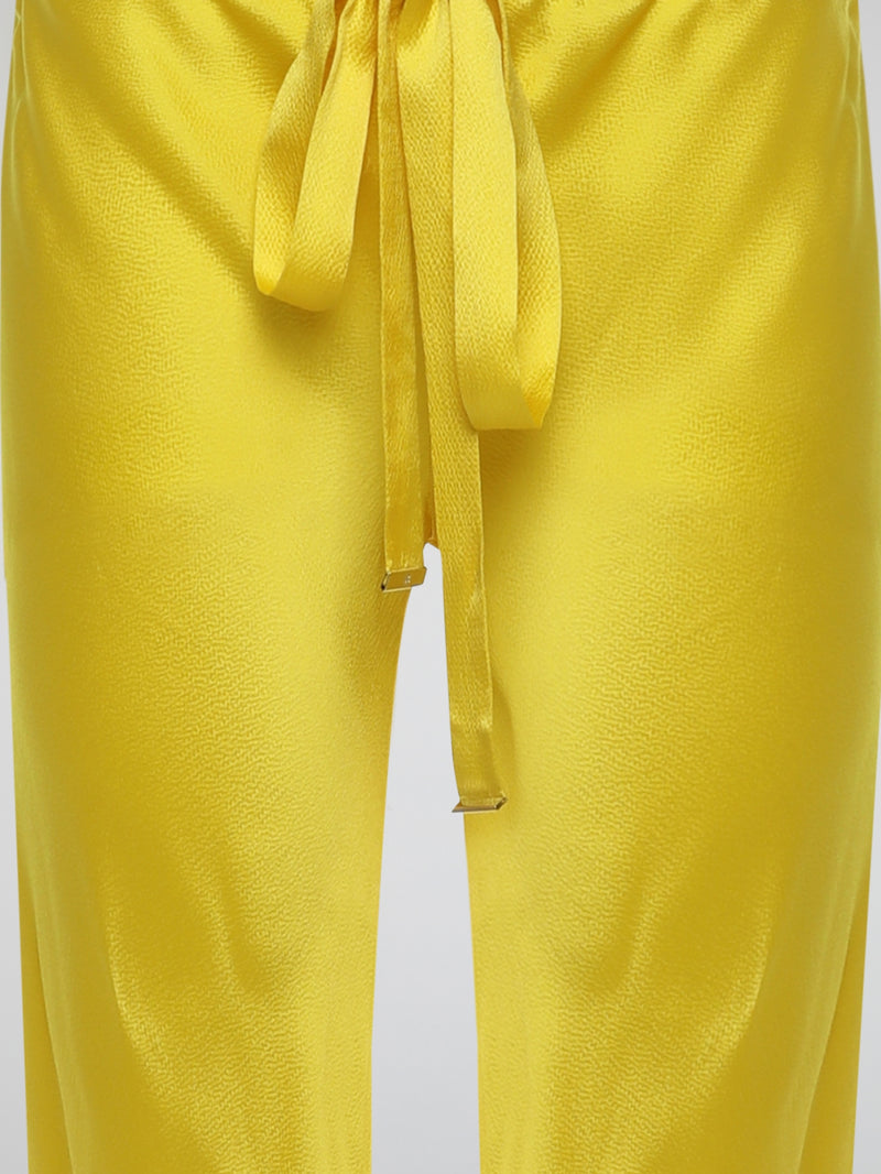 Step up your style game with these vibrant Yellow Drawstring Silk Trousers by Roberto Cavalli. Crafted from luxurious silk, these statement trousers offer a silky soft touch and a flowing silhouette that is both elegant and comfortable. Perfect for any occasion, let these eye-catching pants be the star of your ensemble.