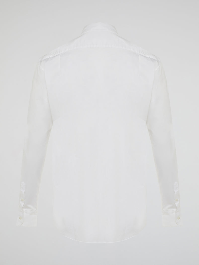 Step into a realm of elegance with the White Embroidered Shirt by Roberto Cavalli, where classic sophistication meets modern charm. Crafted with meticulous attention to detail, this shirt showcases exquisite floral embroidery that dances gracefully across the pristine white fabric. Embrace your inner fashion icon as you effortlessly blend timeless style with a touch of Italian flair, making a statement that is as timeless as it is enchanting.