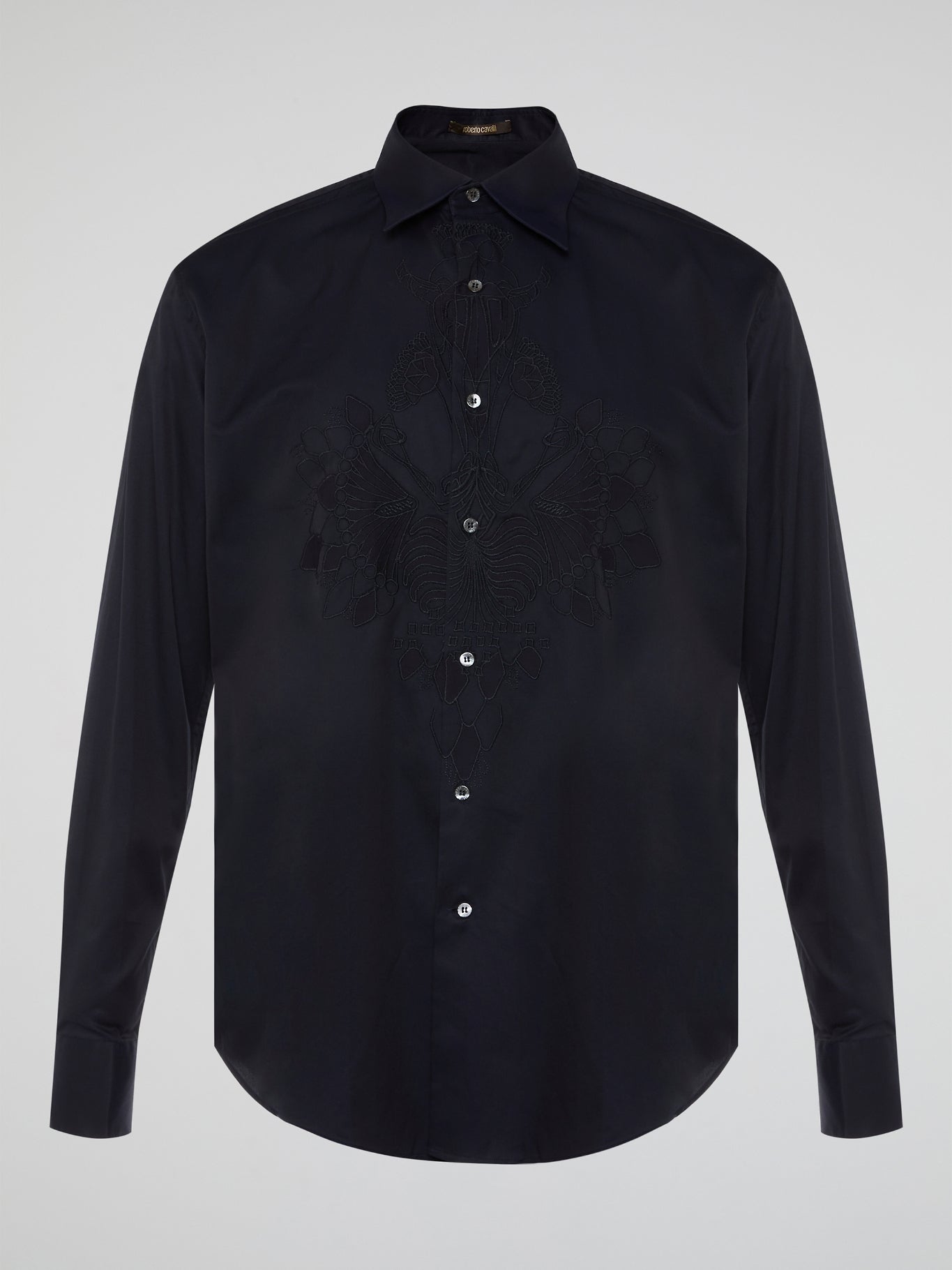 Step into the realm of effortless elegance with the captivating Black Embroidered Shirt by Roberto Cavalli. Adorned with intricate embroidery and delicate lace details, this shirt is a mesmerizing fusion of sophistication and sensuality. Elevate your style with this statement piece that exudes an air of mystique and timeless allure.