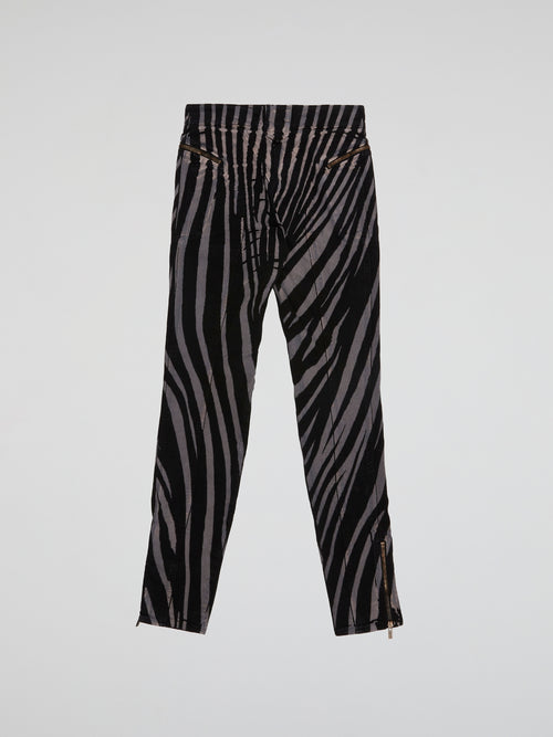 Step into the wild side with these Zebra Print Trousers by Roberto Cavalli and let your fashion roar! Crafted from luxurious fabric, these trendy trousers feature the iconic zebra print, adding a touch of untamed elegance to your wardrobe. Whether paired with a bold blazer or a simple blouse, these trousers are bound to make a fierce fashion statement wherever you go.