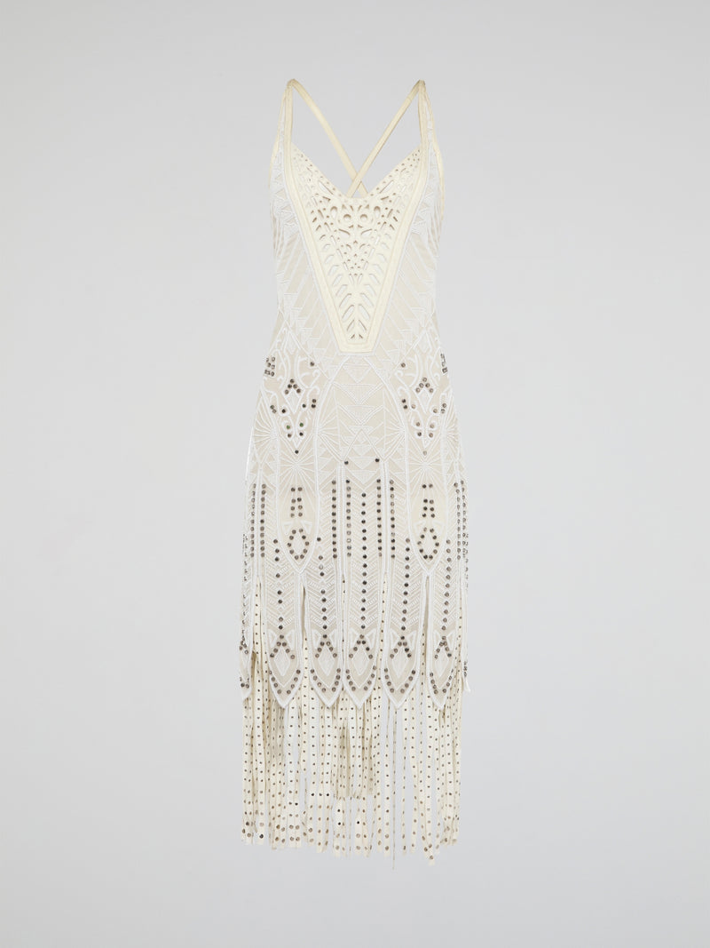 Step out in style in this stunning White Embroidered Fringe Dress from iconic designer Roberto Cavalli. The intricate embroidery detailing and playful fringe trim add a touch of bohemian elegance to this timeless piece. Whether you're hitting the beach or attending a summer soirée, this dress is sure to turn heads and make a statement.