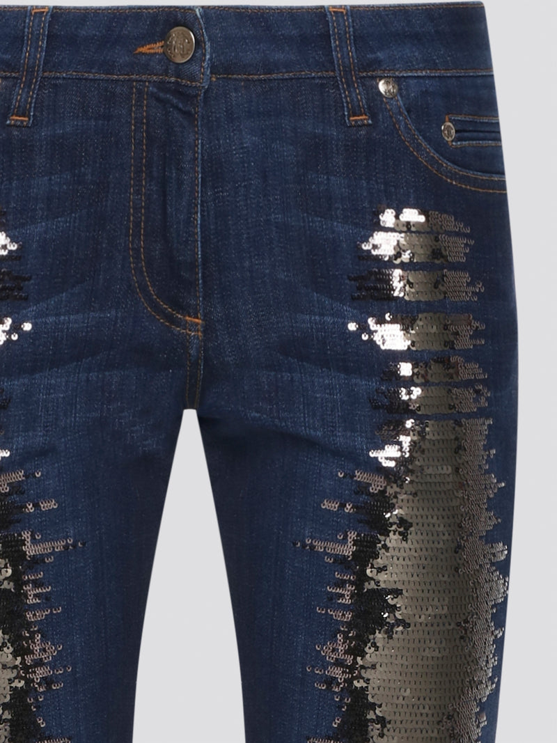 Sparkle and shine in style with these navy sequin embellished jeans by Roberto Cavalli. With a touch of glam and a hint of luxury, these jeans are perfect for adding a touch of sophistication to any outfit. Stand out from the crowd and make a statement with these dazzling denim pants.