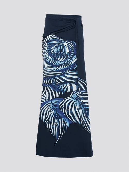 Step into the spotlight with the stunning Navy Foliage Maxi Skirt by Roberto Cavalli. The intricate foliage print cascades down the lush navy fabric, creating a luxurious and elegant look. Perfect for a night out or a special event, this skirt is sure to make a statement wherever you go.