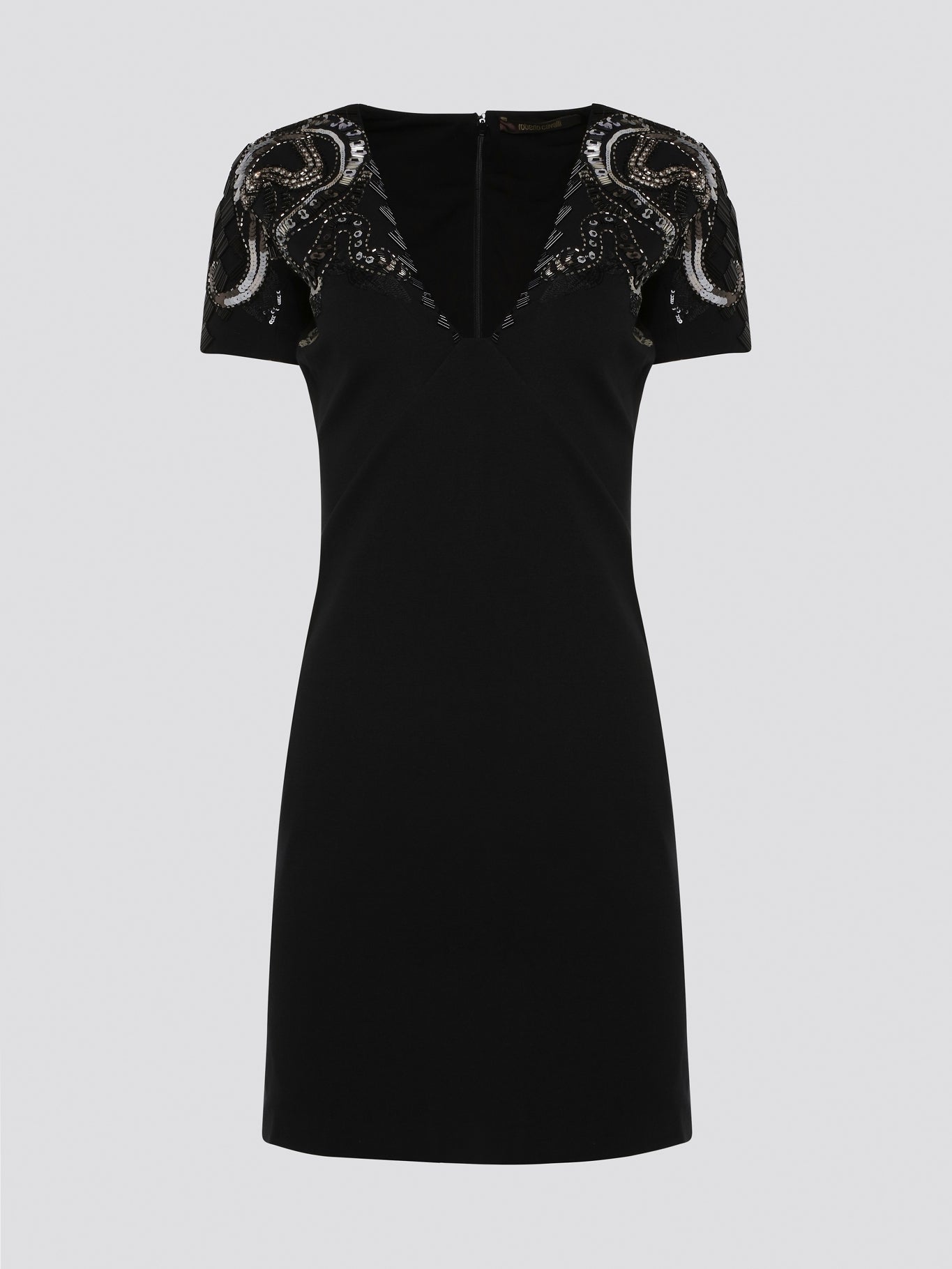 Step out in style and sophistication with our Black Embellished Plunge Dress by Roberto Cavalli. This stunning piece features intricate beadwork and shimmering embellishments that are sure to turn heads. The plunging neckline adds a touch of allure, making it the perfect choice for your next special occasion. Elevate your wardrobe with this show-stopping dress that exudes luxury and glamour.