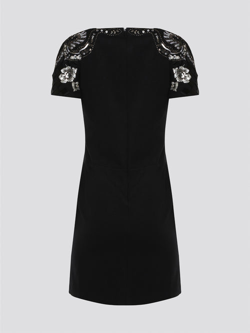 Step out in style and sophistication with our Black Embellished Plunge Dress by Roberto Cavalli. This stunning piece features intricate beadwork and shimmering embellishments that are sure to turn heads. The plunging neckline adds a touch of allure, making it the perfect choice for your next special occasion. Elevate your wardrobe with this show-stopping dress that exudes luxury and glamour.