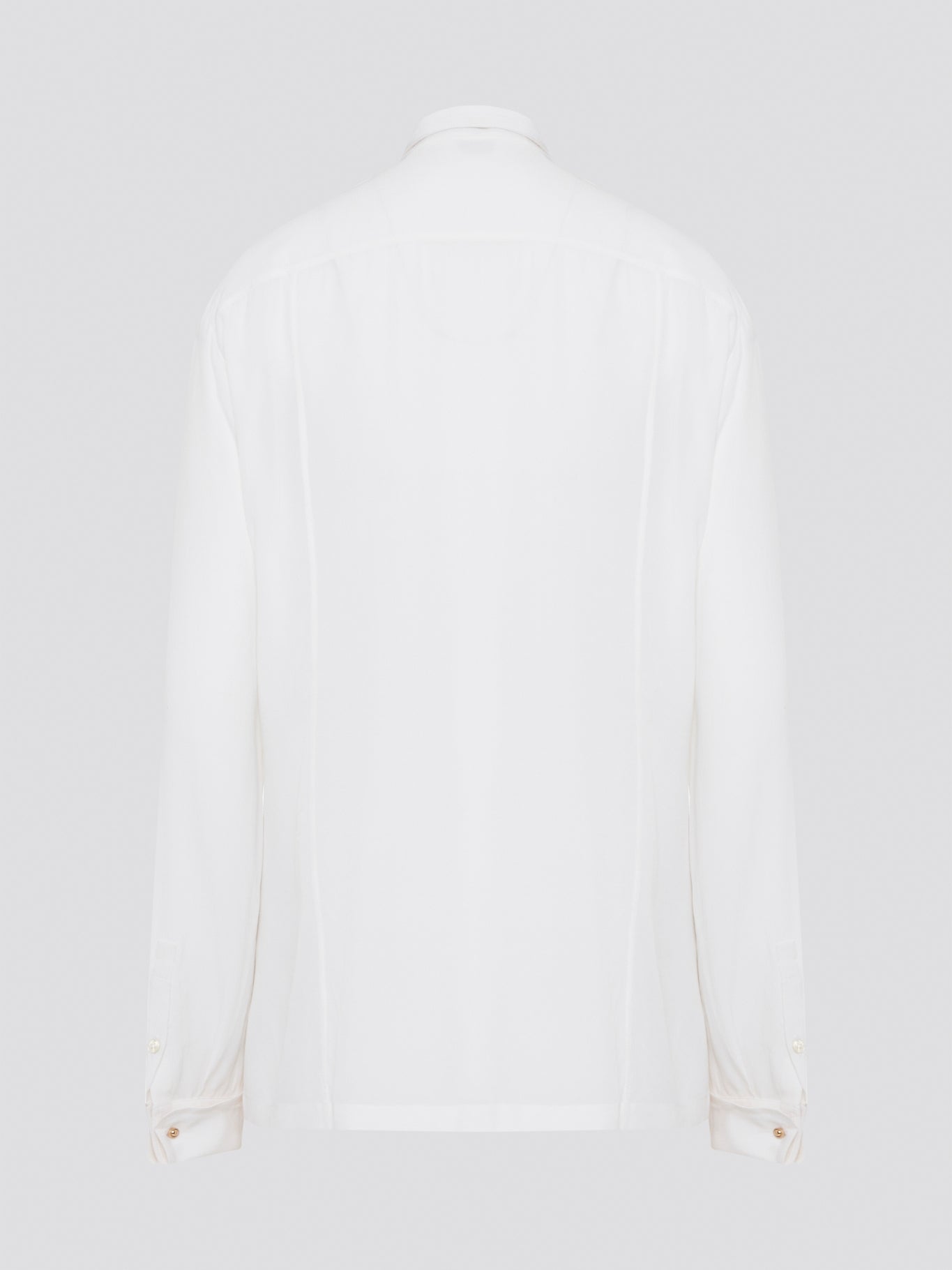 Elevate your wardrobe with this stunning Roberto Cavalli white detailed long sleeve shirt. Crafted with exquisite attention to detail, this shirt features intricate embroidery and embellishments that exude luxury and elegance. Perfect for adding a touch of sophistication to any ensemble, this statement piece is sure to turn heads wherever you go.