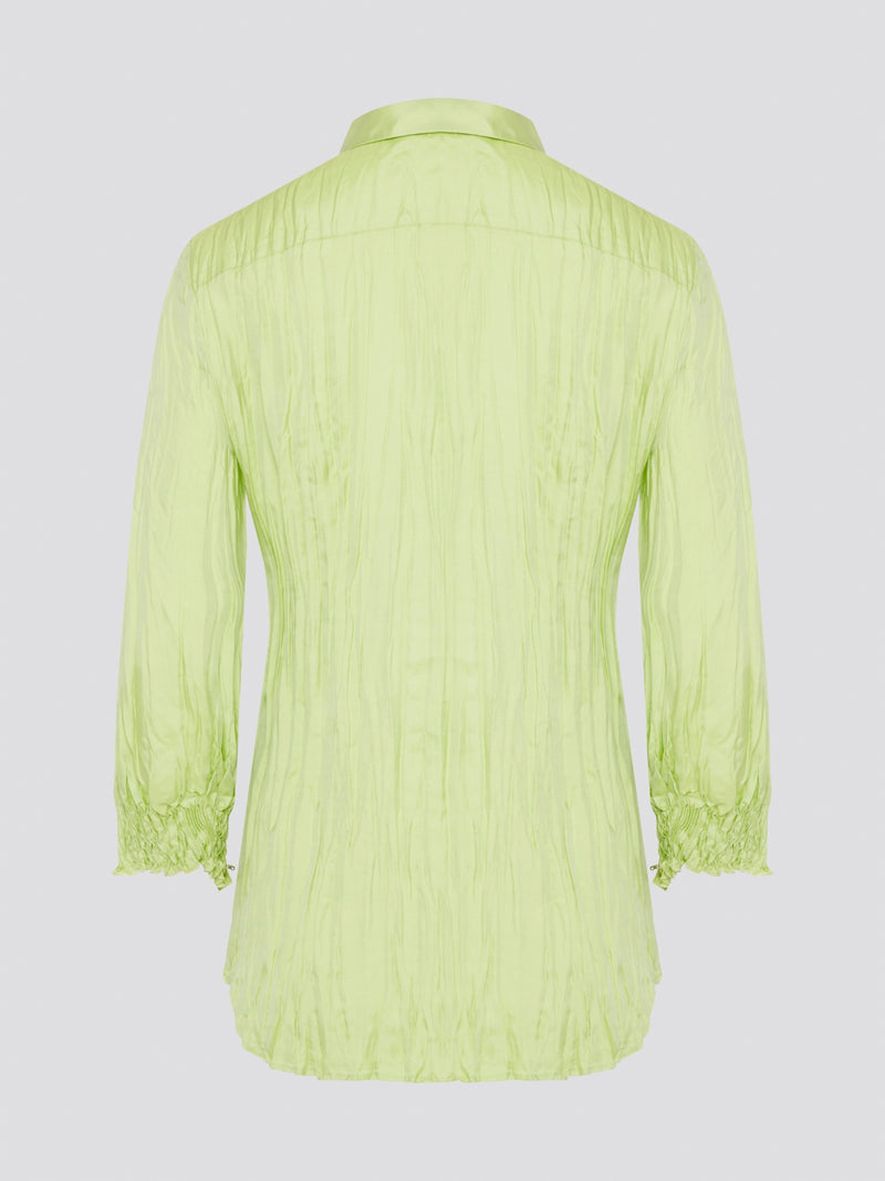 Step into the wild side with this striking green crinkled shirt from Roberto Cavalli. The vibrant hue and unique texture of the fabric will ensure you stand out from the crowd wherever you go. Embrace your fearless fashion sense and unleash your inner style icon with this must-have statement piece.